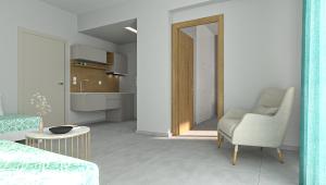 a living room with a chair and a kitchen at Ninemia Beach Hotel & Suites in Agia Marina Nea Kydonias