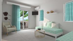 a bedroom with a bed and a chair and a table at Ninemia Beach Hotel & Suites in Agia Marina Nea Kydonias