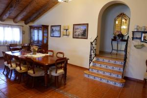 a dining room with a table and a staircase at Mas de la Vall del Frare in Gandesa
