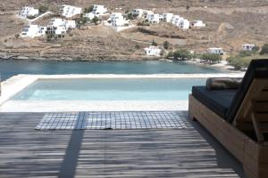a view of a pool from the deck of a house at Amal Kythnos Suites in Kithnos