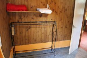 a room with a wooden wall with a shelf at La Colorida in Lago Puelo
