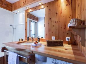 a bathroom with a sink and a large mirror at Triplex élégant proche des pistes avec parking - FR-1-694-164 in Val dʼIsère