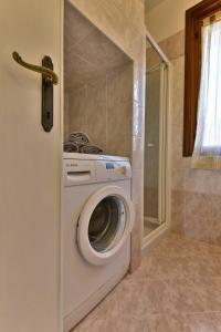 a washer and dryer in a small bathroom at Appartamento Nonna Agnese - Theater Home in Toscolano Maderno
