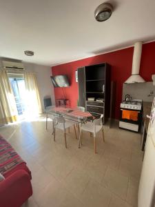 a living room with a table and a stove at Pueblo Nuevo in Junín