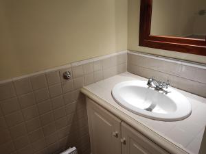 a bathroom with a white sink and a mirror at Le Petit Mas de Grimaud in Grimaud