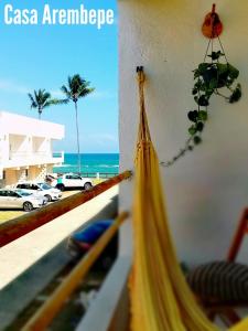 a view of the ocean from a balcony with a hammock at Casa Arembepe in Camaçari