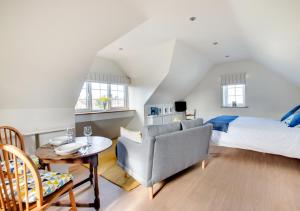 a bedroom with a bed and a table and a chair at Swift Lodge in Kirton