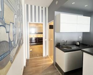 a kitchen with a sink and a counter at Luxurious studio suite near Monaco with sea view in Éze +17 photos