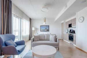 a living room with a couch and a table at Holiday Club Caribia Superior Apartments in Turku