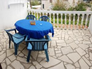 a blue table and chairs on a patio at Apartments Katarina in Vis