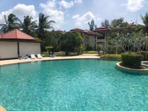 a swimming pool in front of a house at Pool Villa Phuket 2 bedroom in Layan Beach