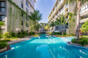 a swimming pool in the middle of a building at Daimond Exclusive Junior Suite Bangtau Beach in Bang Tao Beach