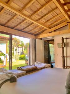 two beds in a bedroom with a wooden ceiling at Villa Margaridi in Guimarães