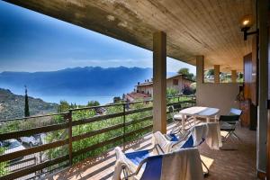 a balcony with a table and chairs and a view at Belvedere Beatrice - Rebomaholidays in Olzano