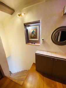 a room with a picture on the wall and a mirror at Saint Estève maison authentique et charme assuré in Saint-Estève