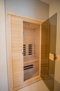 a bathroom with a closet with a window in it at Penthouse Royal, Luxurious and cozy with Sauna in Cadzand