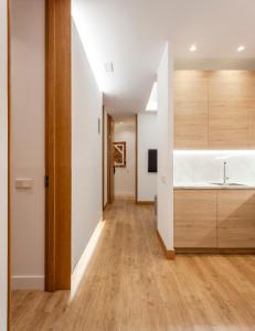 a kitchen with wooden cabinets and a sink at San Bernardino 15 in Madrid