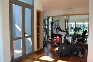 a gym with treadmills and ellipticals in a room with windows at Brava P14 - 1 dorm. (sin sabanas y sin toallas) in Punta del Este