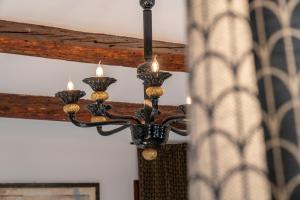a chandelier with candles hanging from a ceiling at Palazzo San Luca in Venice
