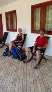 twee mensen zitten in stoelen op een veranda bij Hotel Chanaya in Ambanpola