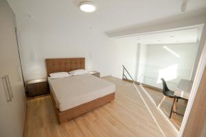 a bedroom with a bed and a desk and a chair at Athens Heart Luxury Apartment in Athens