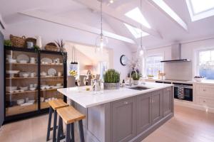 a kitchen with a large island in the middle at Moonwood House in Beaulieu