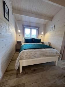 a bedroom with a bed in a small room at Dolmen Lodge. in Donegal