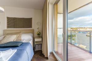 Posteľ alebo postele v izbe v ubytovaní Apartamenty Lighthouse Mrzeżyno