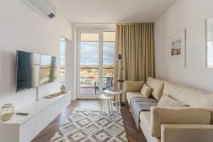 Televízia a/alebo spoločenská miestnosť v ubytovaní Apartamenty Lighthouse Mrzeżyno