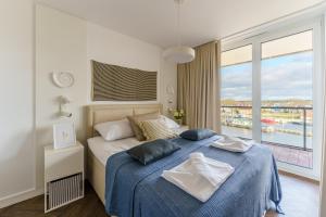 Posteľ alebo postele v izbe v ubytovaní Apartamenty Lighthouse Mrzeżyno
