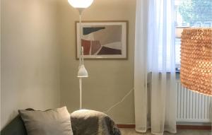 a floor lamp in a living room next to a couch at Amazing Apartment In Kvillsfors in Kvillsfors