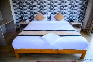 Uma cama ou camas num quarto em Hotel Kaavi