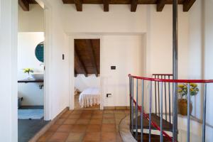 a hallway of a house with a red railing at Villa Tina in Taormina +41 photos