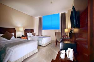 Aston Samarinda Hotel and Convention Center客房内的一张或多张床位
