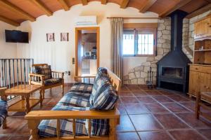 a living room with a couch and a fireplace at Villa Parets de Sucre in Les Cases d'Alcanar