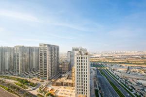 an aerial view of a city with tall buildings at Luxurious Living in Dubai Hills Estate - 1 Bedroom Apartment in Dubai