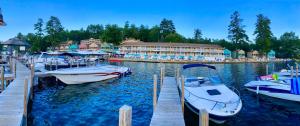 a group of boats docked at a dock with a resort at NASWA Resort in Laconia +14 photos
