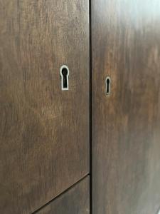 a pair of metal locker doors with a hole in them at Comfort Apartments Oliwa Gdańsk in Gdańsk