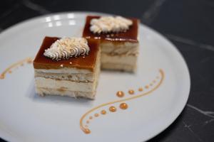 two pieces of cake on a white plate at Apartmani Mozart-centar Virovitica in Virovitica