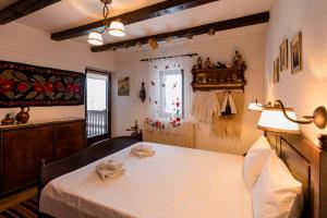 a room with a bed with two towels on it at Casa cu Cerdac in Nucşoara +58 photos