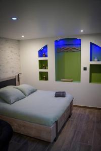 a bedroom with a bed in a room at Nuit de la sagesse "jacuzzi terrasse et parking privé" in Rouen