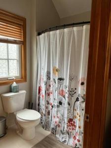 a bathroom with a toilet and a shower curtain at Private, great loc - ideal for long / short stay in Canton