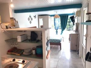 a small kitchen with a sink and a stove at Kaz Anna in Petit-Bourg