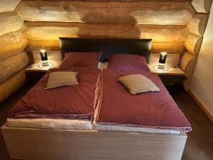 a bed in a room with two lamps on tables at Ferienhof Weisser Hirsch in Werben