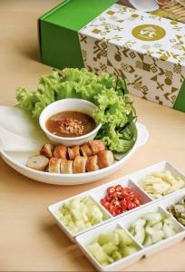 a plate of food with a salad and a bowl of soup at BJ city hotel in Surat Thani