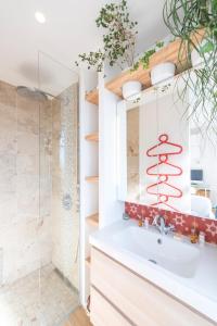 a bathroom with a sink and a shower at Veeve - By the Palais Royal in Paris