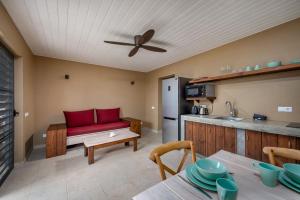 a living room with a red couch and a kitchen at Kura Kabana Resort in Kralendijk