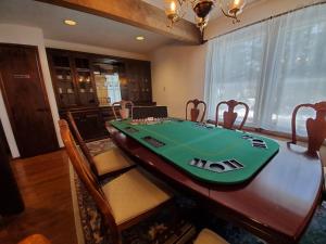 a dining room table with a green board on it at 1 Minute to Pool & Beach, Spacious Getaway, AC, Hot tub, Game room in Pocono Country Place