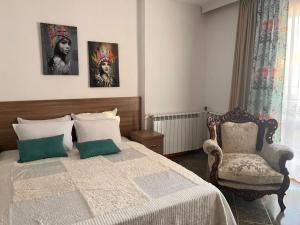 a bedroom with a bed and a chair at Time out in Sozopol