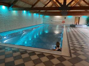 a little girl sitting in a swimming pool at Oak Boutique Lodge includes hot tub air con & dog in York